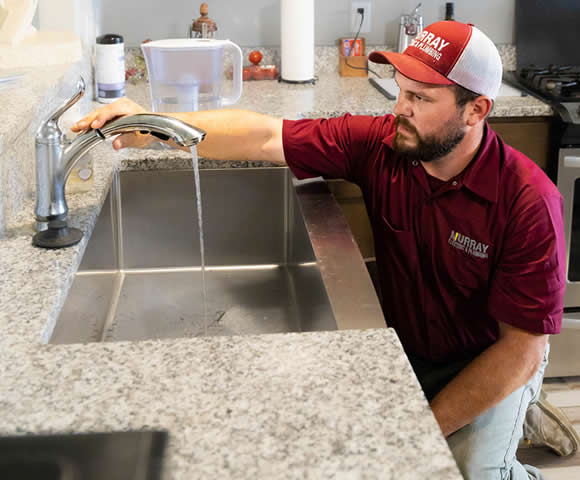 Plumber fixing faucet