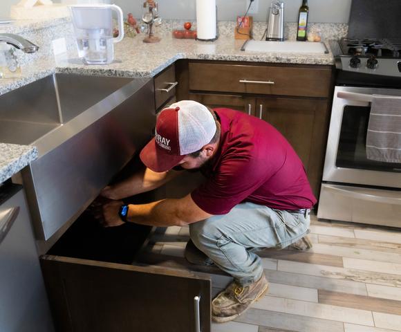Murray plumber inspecting leak