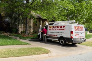 Murray Electric & Plumbing van arriving at a jobsite